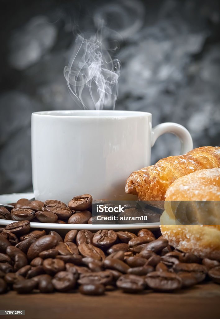 Hot coffee with croissant and donut Italian espresso coffee with smoke on coffee beans 2015 Stock Photo