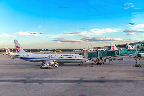 Air China Boeing 777 at Beijing Airport Terminal 3 Beijing, China - June 12, 2015: Air China Boeing 777 parking l at Beijing Airport Terminal Three. It is 3rd largest airline of Asia. air china boeing 777 commercial plane stock pictures, royalty-free photos & images