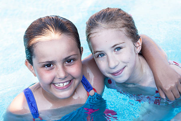 istock cute girls in swimming pool 478413998