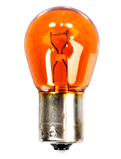 Yellow car indicator bulb on a white background