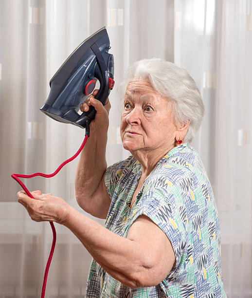 istock Angry old woman with an iron 478419632