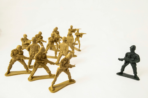 Plastic Lead Soldiers Representing War on a White Background