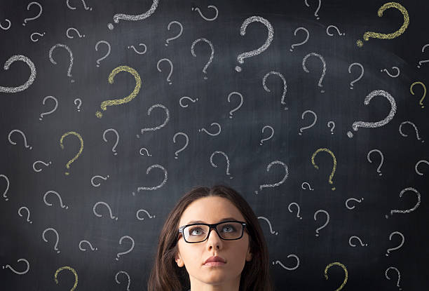 istock Chalk question marks above businesswoman at blackboard 478421960