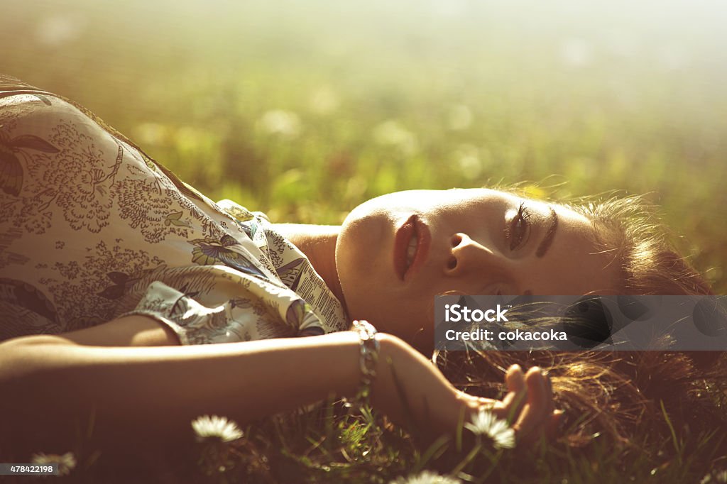 nostalgy delicate beautiful young woman enjoy in sun lie in grass retro look and colors 2015 Stock Photo