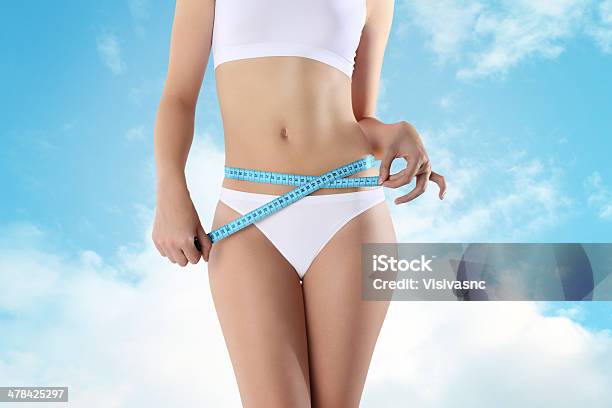 Woman Holding Blue Meter With Hands Near Waistline Stock Photo - Download Image Now - Abdomen, Adult, Adults Only