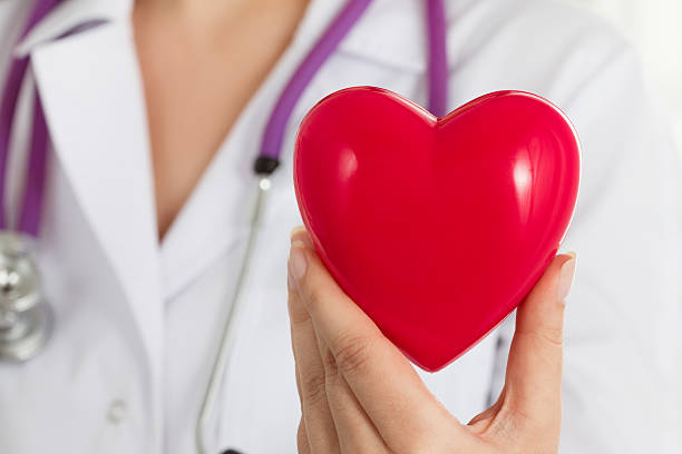 istock Female doctors's hands holding red heart 478425332