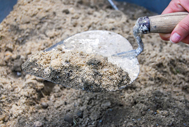 istock Mixing a cement powder with sand 478426542