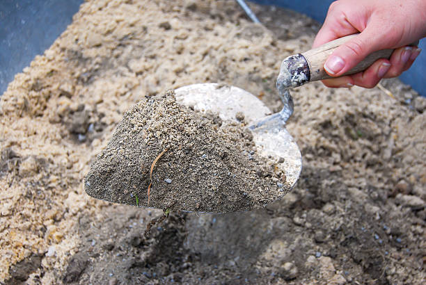 istock Mixing a cement powder with sand 478426546