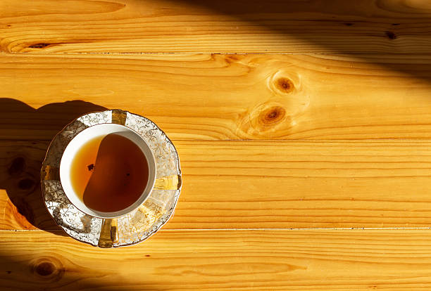 antique porcelain tea cup on wooden background