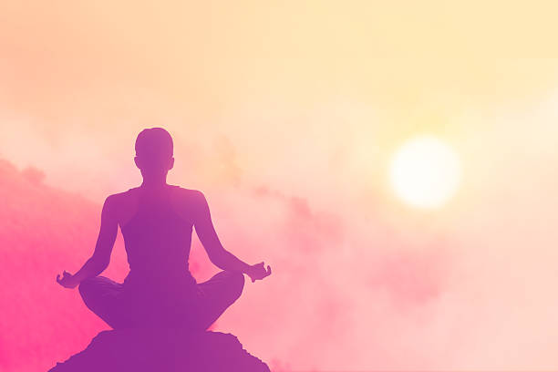 istock women meditating pastel on high mountain in sunset background 478428282