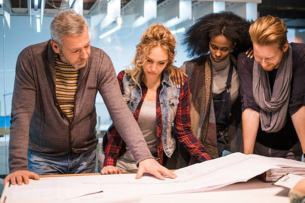 istock Architects working together on blueprints in the office. 478437002