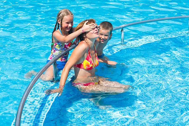 istock Family in the swimming pool. 478437597