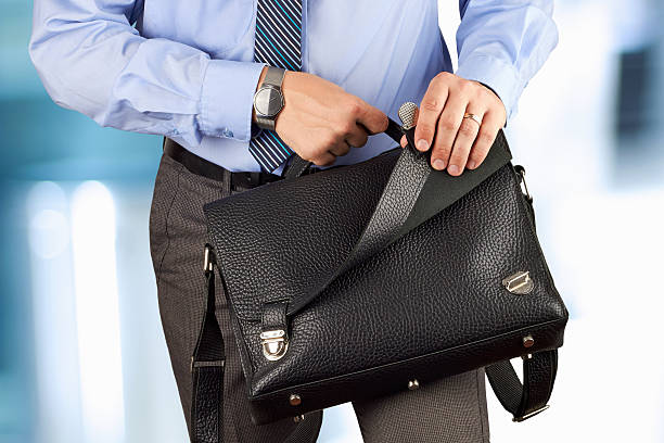 istock Businessman holding and opening  a  leather briefcase 478437860