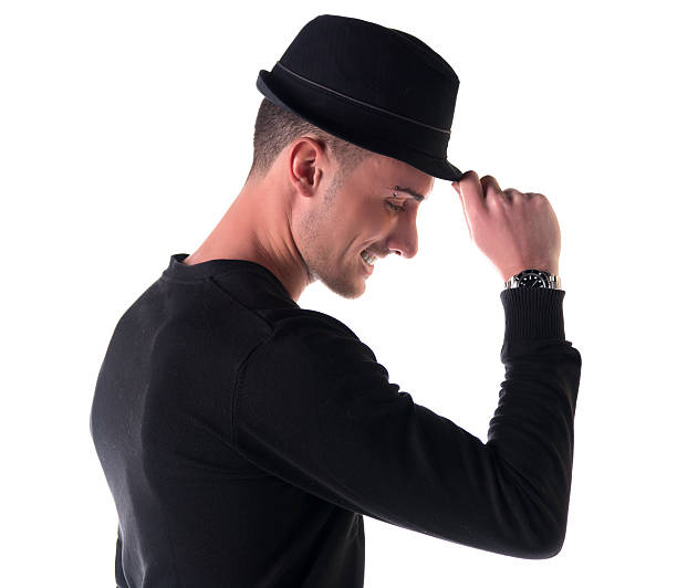 istock Profile shot of young man smiling, touching fedora hat 478438073