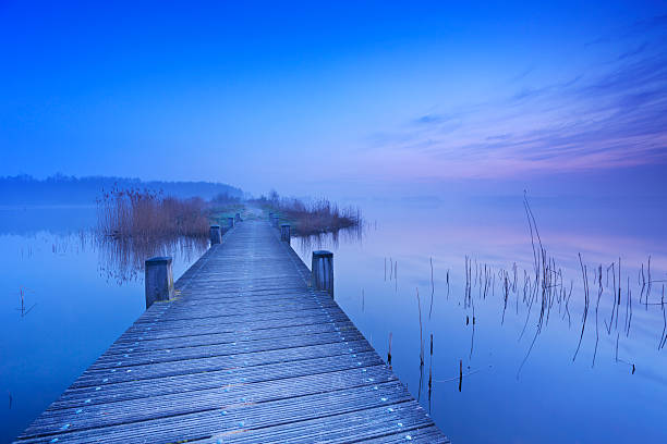 istock Boardwalk over water at dawn in The Netherlands 478438396