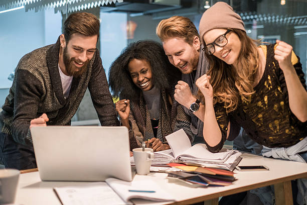 istock Cheerful start up team celebrating their success in the office. 478441744
