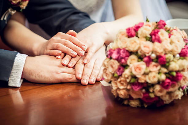 istock Hands with wedding rings amd bouquet 478442183