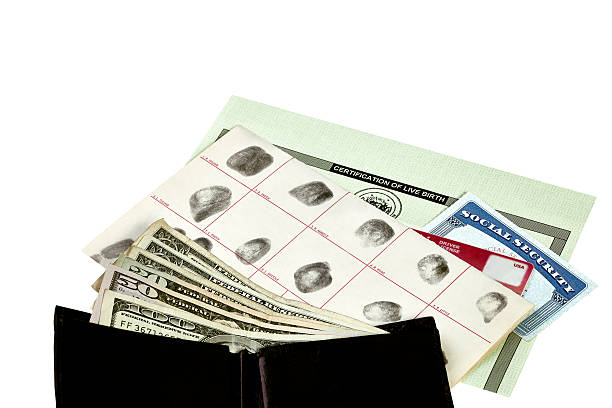 Identity Documents with Wallet and Currency Fingerprint card, driver's license, social security card and birth certificate isolated on white with wallet and paper money social security social security card identity us currency stock pictures, royalty-free photos & images