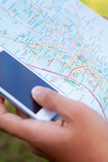 istock Man hand looking direction with maps and mobile phone 478442754