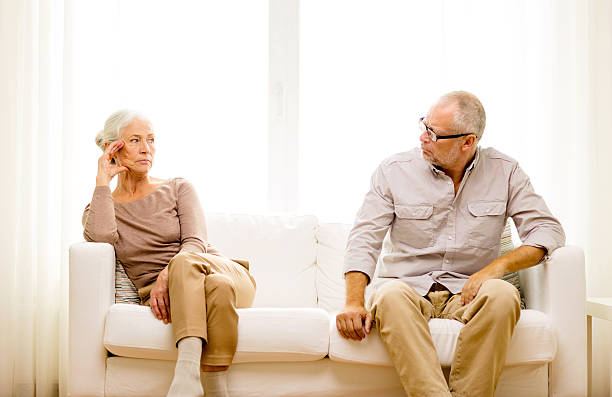 istock senior couple sitting on sofa at home 478445732