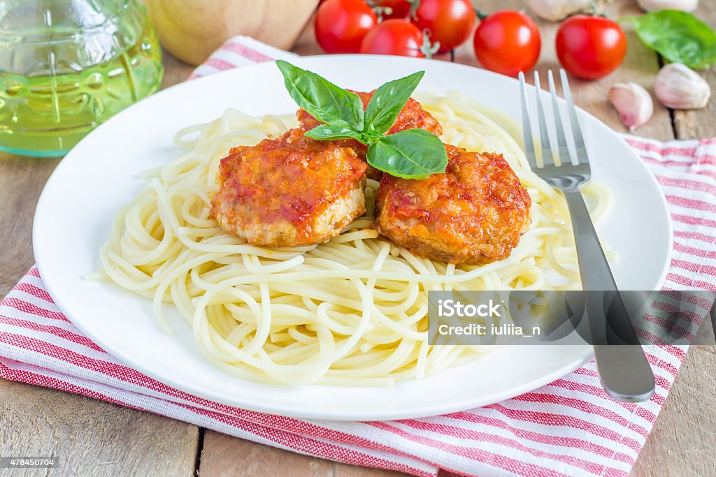 Meatballs in tomato sauce with spaghetti Meatballs in tomato sauce with spaghetti on a white plate 2015 Stock Photo