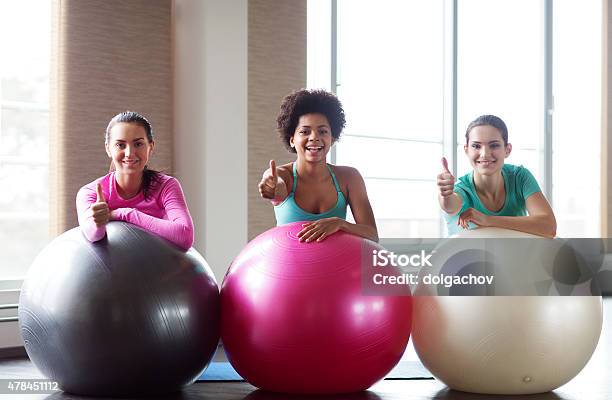 Group Of Smiling Women With Exercise Balls In Gym Stock Photo - Download Image Now - 2015, Active Lifestyle, Activity