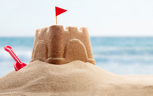 Holiday concept with sandcastle on the seaside