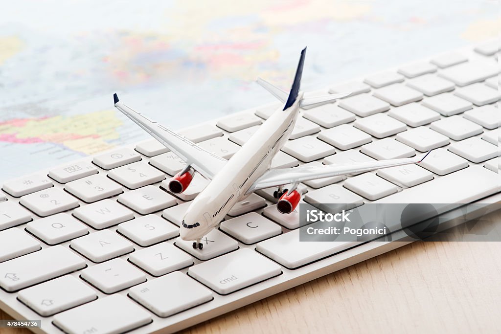 Online travel Model airplane on computer keyboard Travel Agency Stock Photo