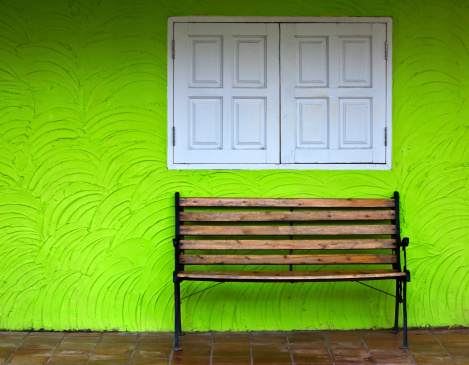 Wood chair on green wall background