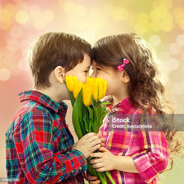 Happy Boy And Girl With Bouquet Of Flowers Stock Photo - Download Image Now - Adult, Baby - Human Age, Baby Clothing