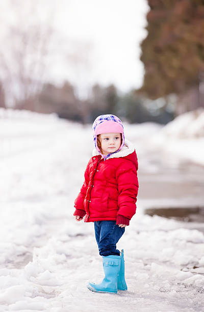 istock Girl Standing in Snow 478457743