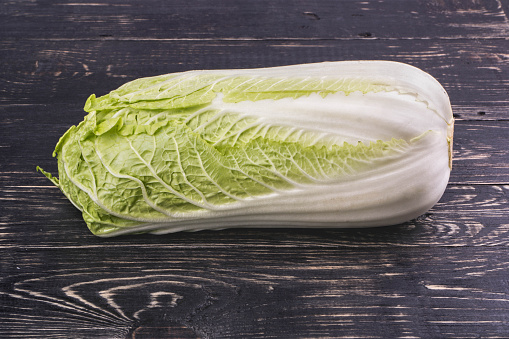Fresh ripe chinese cabbage on a dark wooden background