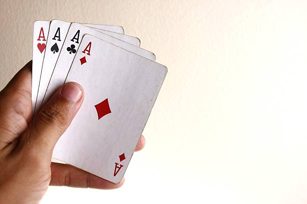 istock Hand holding Four aces of a playing card deck 478460642