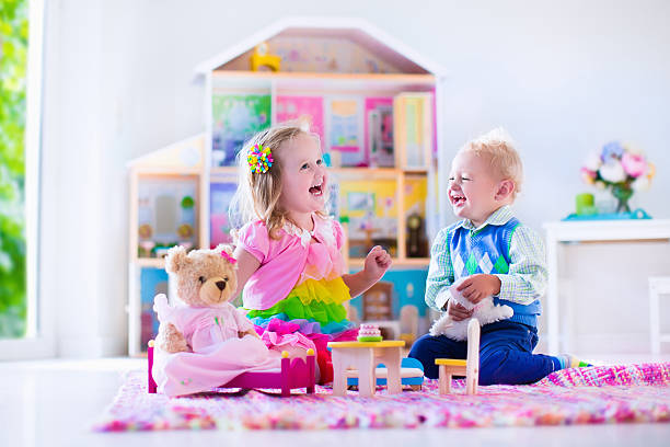 istock Happy kids playing with stuffed animals and doll house 478461144