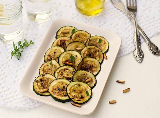 istock Antipasto of grilled courgette zucchini with pine nuts 478461316