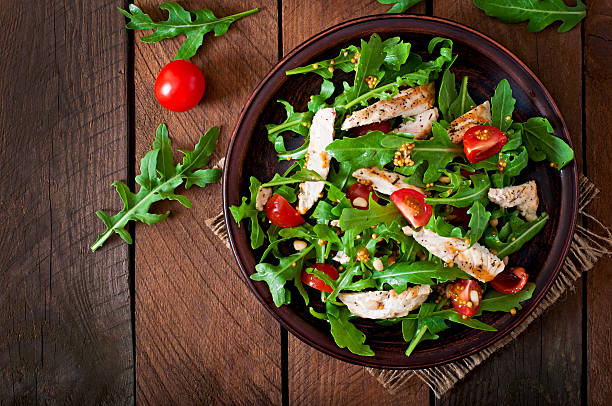 Fresh salad with chicken breast, arugula and tomato Fresh salad with chicken breast, arugula and tomato arugula stock pictures, royalty-free photos & images