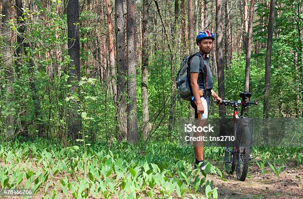 Young Man Standing In The Forest Stock Photo - Download Image Now - 2015, Activity, Adult