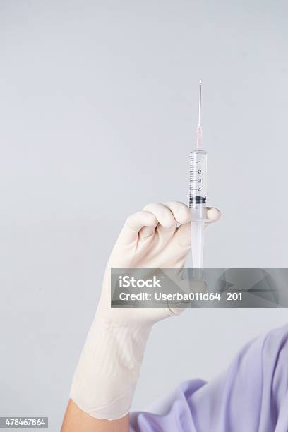 Doctors Hands Holding Syringe Closeup On White Background Stock Photo - Download Image Now