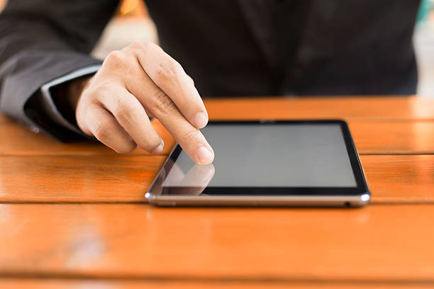 istock Digital tablet computer with isolated screen in male hands 478471188