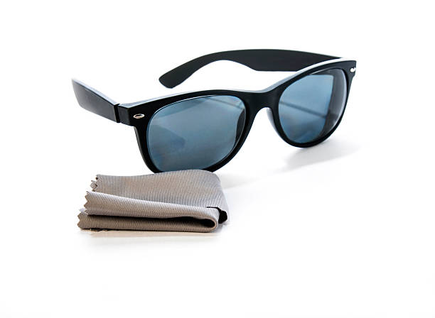 Prescription sunglasses with black,rubber frames and blue, polarized lenses. A microfiber lens cleaning cloth is in the foreground.