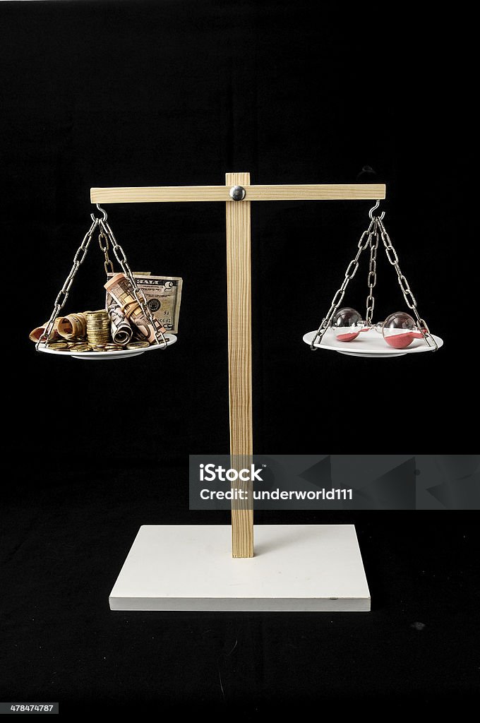 Clock and Currency Time is Money Concept Time is Money Concept Clock and Currency on a Two Pan Balance Business Stock Photo