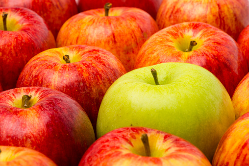 Red apples and red apples slices levitating in air isolated on white background.