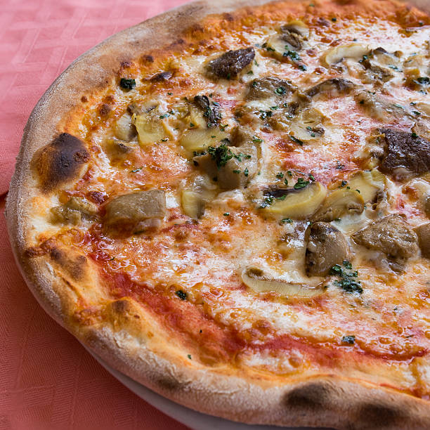 Mushrooms pizza half left side In the picture typical Italian pizza  with tomato,mozzarella,cheese and mushrooms. Cepe stock pictures, royalty-free photos & images