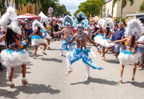 Miami, Florida, USA - March 9, 2014: Group of carnival dancers at 2014 Miami's Little Havana Calle Ocho Festival. Little Havana hosts its annual Calle Ocho street festival (part of the overall Carnaval Miami celebration), one of the largest in the world, with over one million visitors attending Calle Ocho alone. It is a free street festival with a Caribbean carnival feel sponsored by the Kiwanis Club of Little Havana.