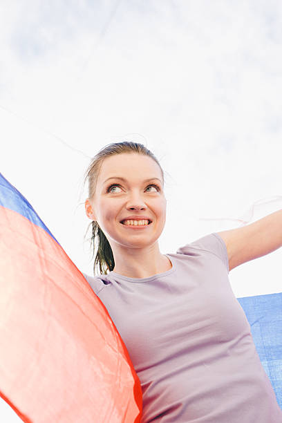istock Cheering Woman Under Russian Flag 478489984