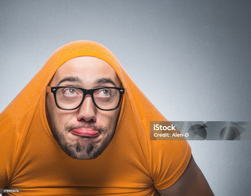 Funny guy - man Funny thoughtful man looking up, isolated on gray background. Closeup, studio shot People Stock Photo