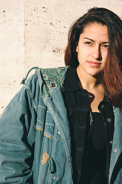 istock Latin woman in front of a wall at sunset 478493684