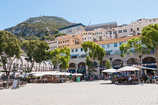 Gibraltar, United Kingdom - August 27, 2014: Tourists visit Grand Casemates Square. The square is lined with numerous pubs, bars and restaurants and acts as the gateway into Gibraltar's city centre.