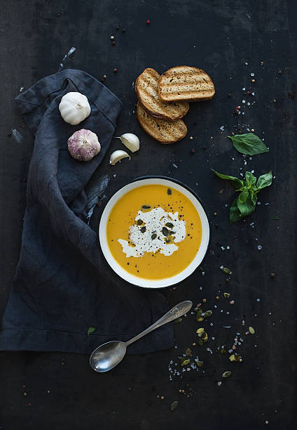 istock Pumpkin soup with cream, seeds, bread and fresh basil on 478502800