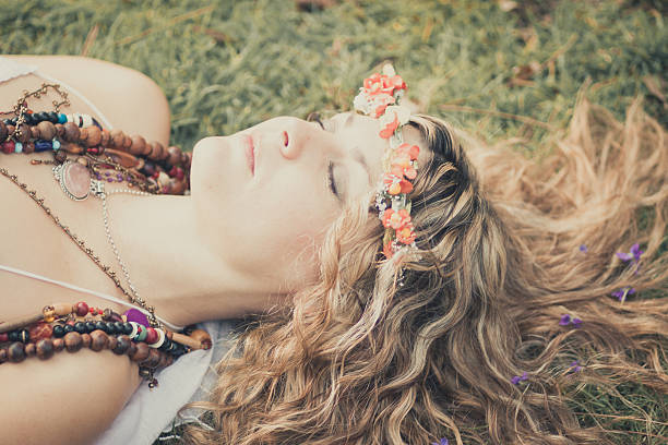Young woman lying in grass dreaming summer day